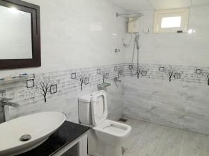 a bathroom with a toilet and a sink at Rustic Villa 7 in Weligama