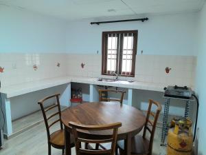 a kitchen with a table and chairs and a sink at Rustic Villa 7 in Weligama