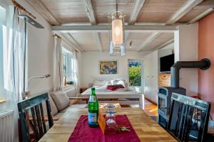 a dining room with a table and a bedroom at Öko Fewo Sturmmöwe in Kiel
