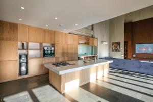 a large kitchen with a counter and a refrigerator at Ahoy! 9 Bedroom Villa in Dalung