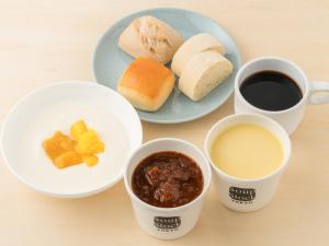a table with a plate of bread and two cups of coffee at Hotel Villa Fontaine Tokyo-Hamamatsucho in Tokyo