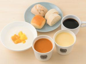 a table with three cups of coffee and a plate of bread at Hotel Villa Fontaine Tokyo-Hamamatsucho in Tokyo