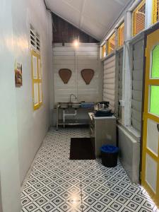 a small bathroom with a sink and a tub at Arau Heritage Home in Arau +5 photos