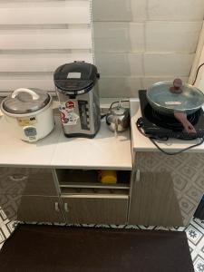 a counter with a toaster and a slow cooker on it at Arau Heritage Home in Arau