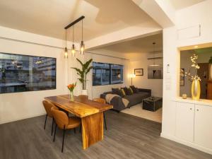 a kitchen and living room with a table and a couch at 2-Bedroom Penthouse in the heart of Silom - 4A in Bang Rak