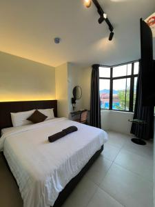 Kangsar KK Hotel客房内的一张或多张床位