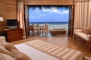 a hotel room with a view of the ocean at Adaaran Prestige Water Villas - with Dine around Premium All inclusive - 24 hours in Raa Atoll