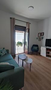 a living room with a green couch and two tables at Casa Yaye Puerta Palma - Écija in Écija +22 photos