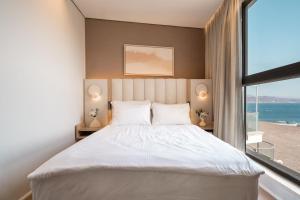 a bedroom with a large bed and a large window at Queen Anne - Penthouse apartment with private pool in Eilat +69 photos