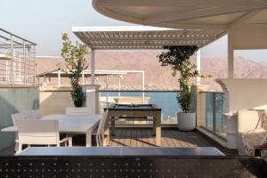 a balcony with a table and chairs on a boat at Queen Anne - Penthouse apartment with private pool in Eilat