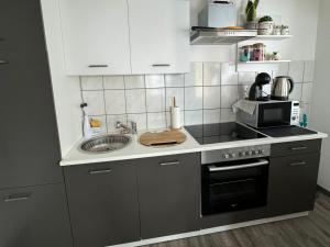 a kitchen with a sink and a stove top oven at R&A in Elsdorf