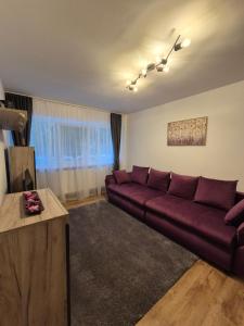 a living room with a couch and a table at Family Residence Slănic-Moldova in Slănic-Moldova