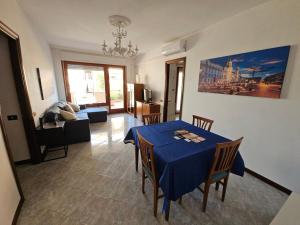 a dining room with a blue table and chairs at Roma, Aeroporto Ciampino e Castelli Romani in Rome