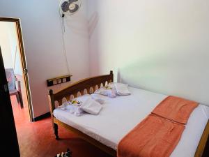 Ένα ή περισσότερα κρεβάτια σε δωμάτιο στο Raja Guest House