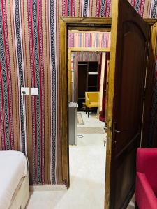 a bedroom with a door open to a room with colorful wallpaper at Moon rum 2 in Disah +95 photos