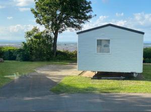 a small white building on the side of a road at Sea View in Port Seton