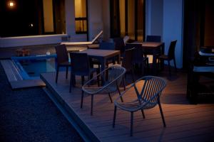 a restaurant with tables and chairs next to a pool at Nanki Shirahama Villa IRIS in Kanayama