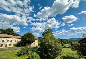 a blue sky with clouds over an old building at L'Ostal de Soubrey in Salettes
