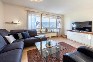 a living room with a couch and a glass table at Fewo Bodenseeoase in Wangen