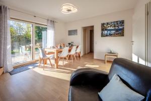 a living room with a couch and a table with chairs at Fewo Bodenseeoase in Wangen