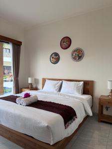 Ένα ή περισσότερα κρεβάτια σε δωμάτιο στο Omah Santai Guest House Canggu +6 φωτογραφίες