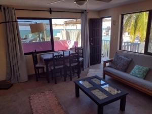 a living room with a couch and a table at Beautilful ocean views from this apartment in Chelem