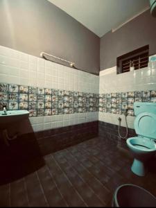 a bathroom with a toilet and a sink at The Varkala Retreat Villa in Varkala