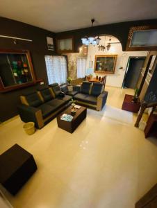 a living room with a couch and a table at The Varkala Retreat Villa in Varkala