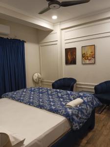 a bedroom with a bed with a blue blanket on it at Fully furnished 1BHK, Bahria heights 1 in Rawalpindi