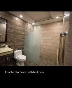 a bathroom with a shower and a toilet and a sink at Fully furnished 1BHK, Bahria heights 1 in Rawalpindi +20 photos