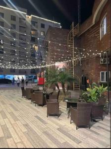a courtyard with tables and chairs and lights at Fully furnished 1BHK, Bahria heights 1 in Rawalpindi