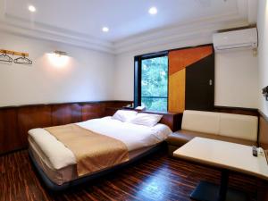 Una cama o camas en una habitación de ホテルスクエア沼津