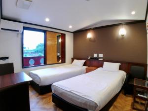 Una cama o camas en una habitación de ホテルスクエア沼津
