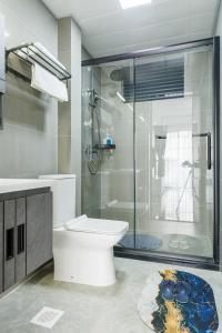 a bathroom with a toilet and a glass shower at Riverside Lux condo in Nairobi