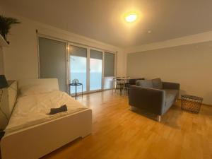 a bedroom with a bed and a chair and a table at 3-Zimmer-Monteurswohnung in Werder für 6 Personen in Glindow