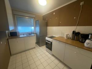 a small kitchen with a sink and a stove at 3-Zimmer-Monteurswohnung in Werder für 6 Personen in Glindow