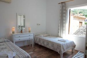 Posteľ alebo postele v izbe v ubytovaní Mirto Apartments