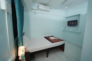 a room with a bench with a cake on it at Hotel Ramlalla Palace in Ayodhya +28 photos