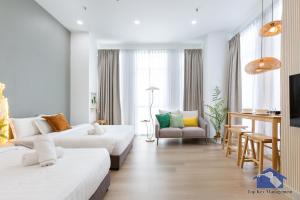 a hotel room with two beds and a chair at Maritime in George Town