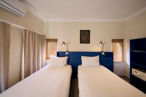 Postel nebo postele na pokoji v ubytování Sedia Hotel