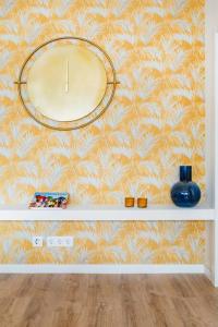 a wall with a large clock on a wall at A Coastal Retreat in Oeiras in Paço de Arcos