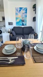 a table with plates and wine glasses on it at Estudio Mediterráneo in Nerja