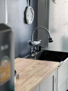 a kitchen counter with a sink and a sink at Baan Peang Ploen Takiab Beach by Cloud9Stays in Hua Hin