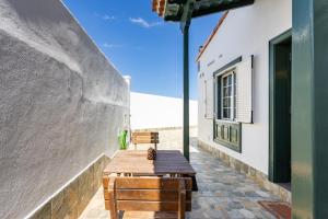 a wooden table and benches on a patio at Abades Private Pool By Sunkeyrents in Abades