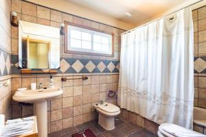 a bathroom with a sink and a toilet and a window at Abades Private Pool By Sunkeyrents in Abades +20 photos