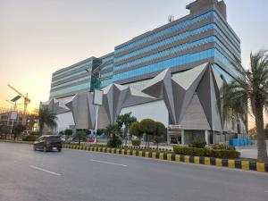 a car driving in front of a large building at One bed furnished appartment in Darwāla