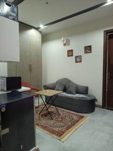a living room with a couch and a table at One bed furnished appartment in Darwāla