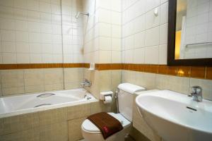 a bathroom with a tub and a toilet and a sink at Baan Chuan Chom Pattaya in Pattaya Central +7 photos