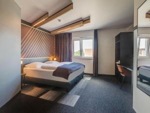 Postel nebo postele na pokoji v ubytování B&B Hotel Oldenburg