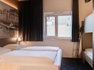 Postel nebo postele na pokoji v ubytování B&B Hotel Oldenburg